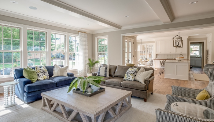 Open concept home with a big distinctive rug in the living area and a smaller one in the dining space