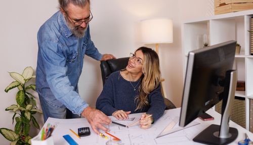 2 Co-Workers looking over Plans