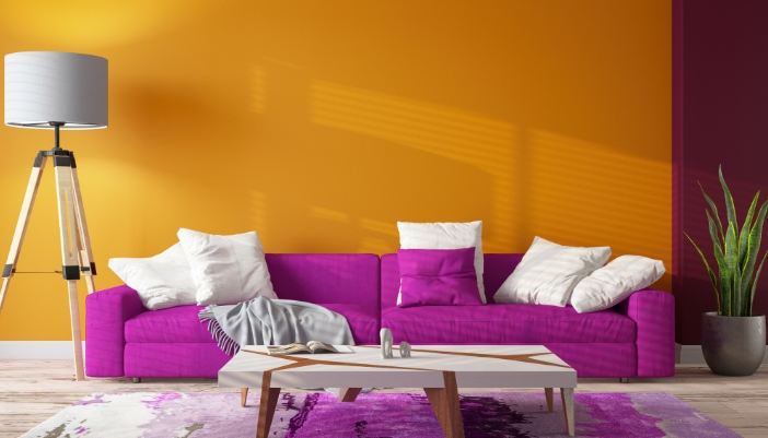 A living room with a bright, neon purple sofa