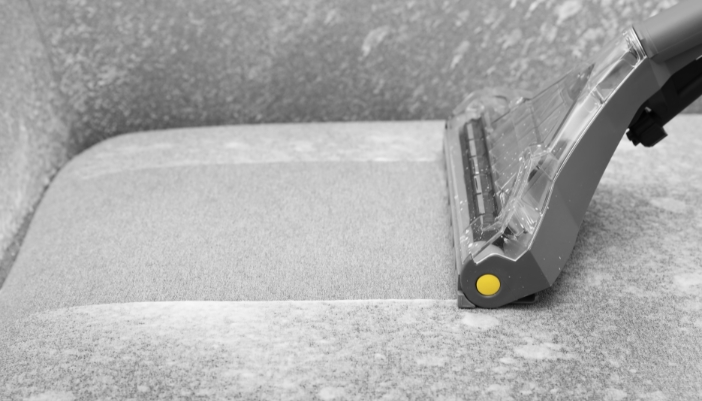 Closeup of someone cleaning a high-quality synthetic couch