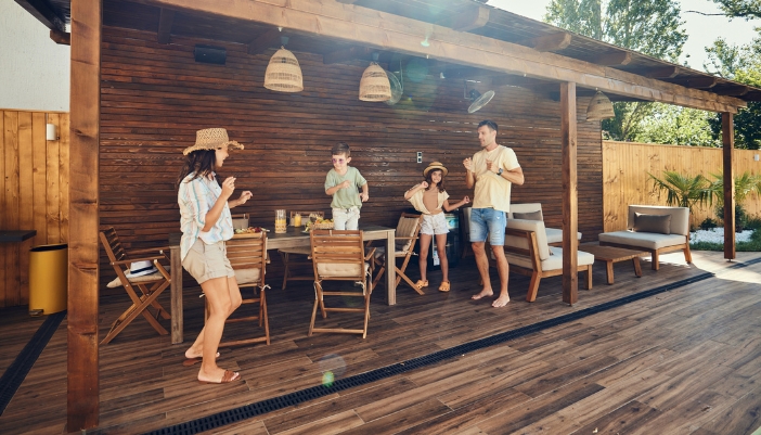 A family having fun on their patio with a dinner al fresco