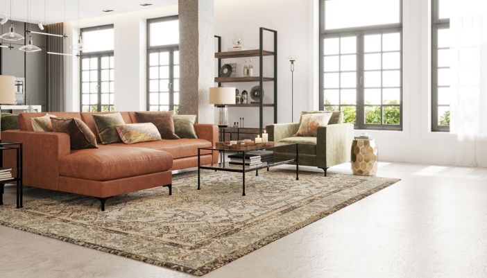 An L-shaped leather couch sits in an open, well-lit modern living room.