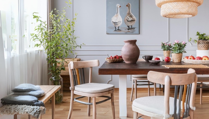 A dining room with natural wood furniture and many green/wooden accents.