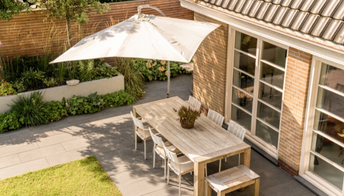 A back patio with a dining area and shade
