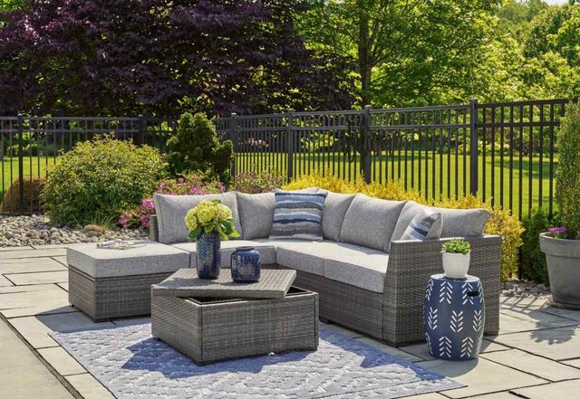 Front view of an outdoor space with a Signature Design by Ashley outdoor patio set