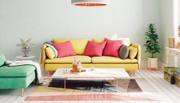 A living room with a yellow couch and green chair to highlight bold summer colors.