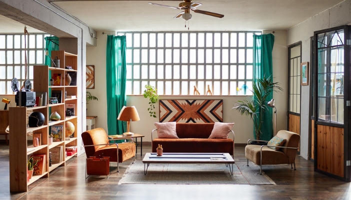 Modern but retro living room with a bookcase used as room divider.