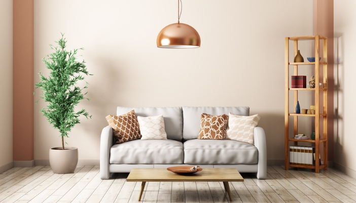 A bright, neutral and wooden living room with a natural bookcase in the corner.