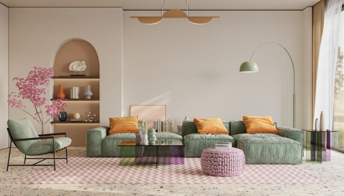 A long green couch sits on a pastel pink rug. 