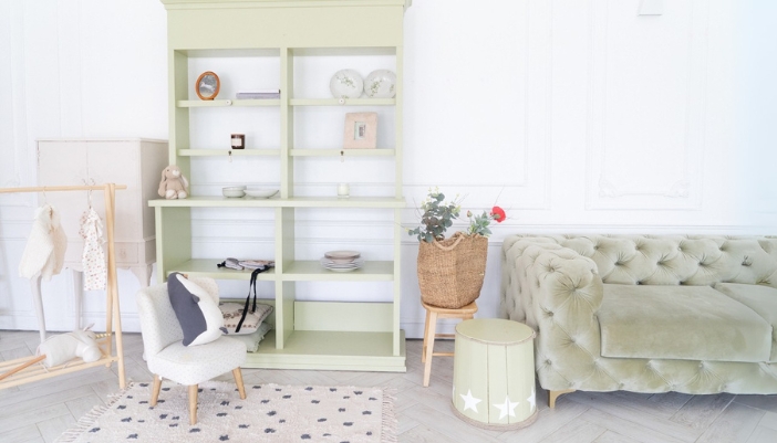 A pastel green open hutch in a children’s play area. 