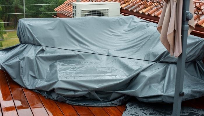 Outdoor furniture covered during rainy day