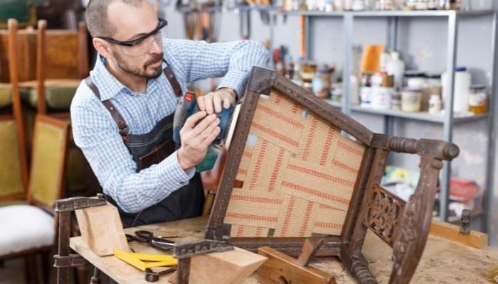 Man repairing outdoor chair