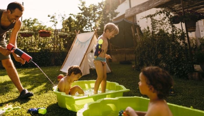 Family having fun with water guns and buckets