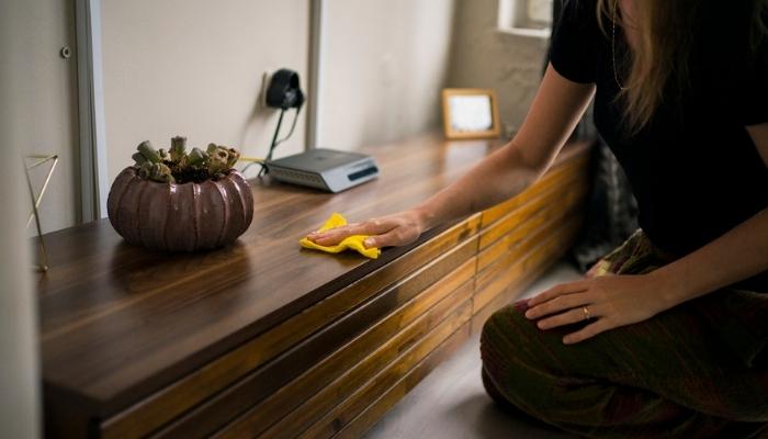woman cleaning wood furniture