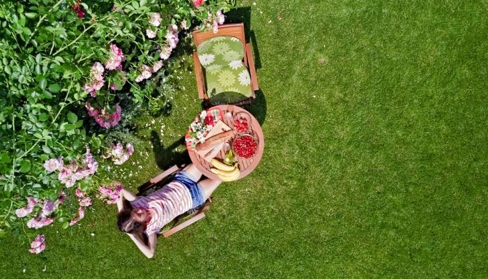 Woman enjoying food next to garden
