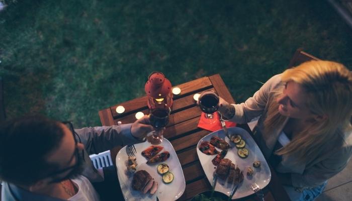 couple having romantic backyard barbecue