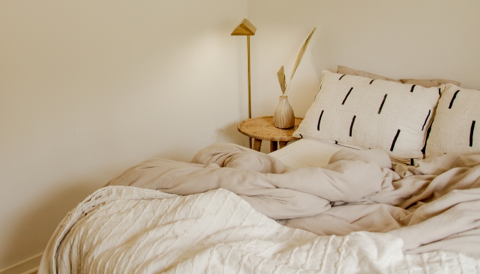 Bed placed under a big tall window