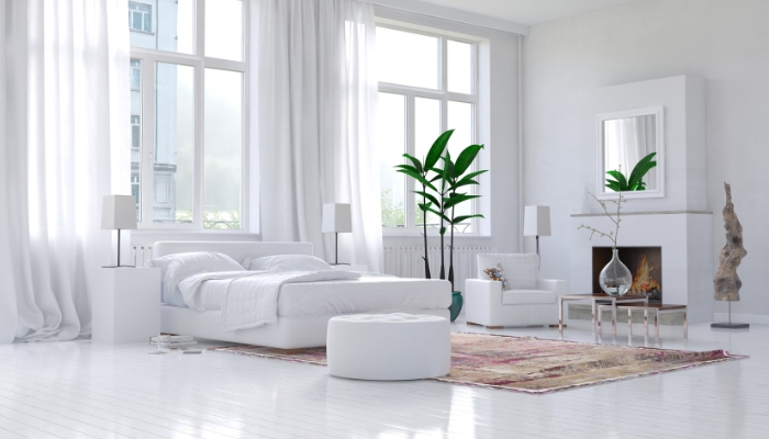 Bed placed under a big tall window