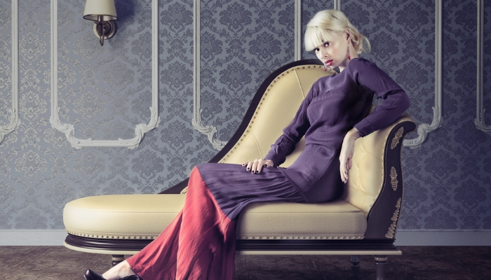 Contemporary model posing on a stylish chaise lounge