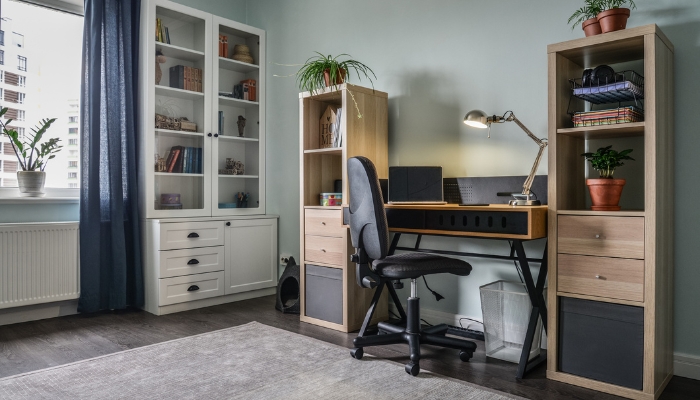 Home office space in the corner of a room near a window
