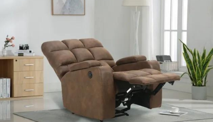 A brown recliner sits with the footrest up in a neutral living room.