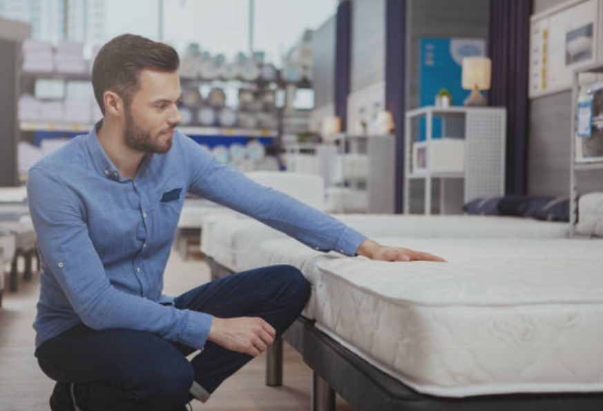 man shopping for a mattress