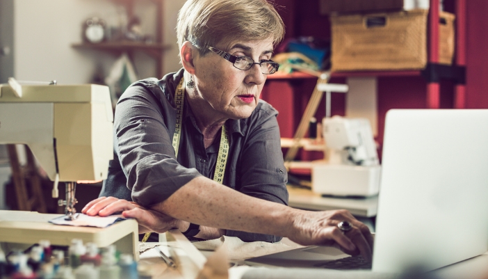 A seamstress hard at work in a colorful space