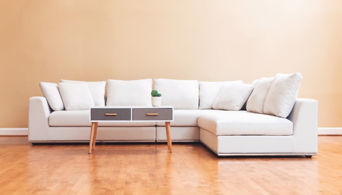 A modular sectional with a drawer coffee table and small succulent on top