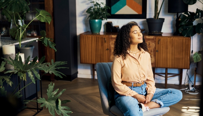Woman with her eyes closed taking in the relaxation vibes of her home