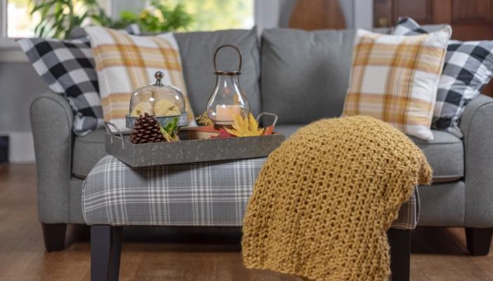 A warm living room with plaid and warm neutrals