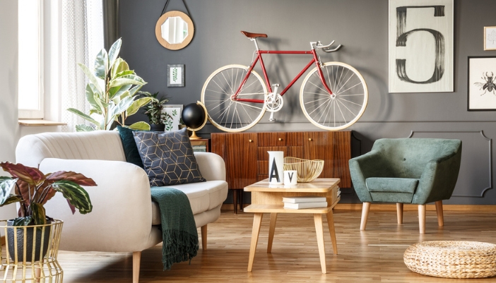 A retro inspired living room with bold cool colors and a bike as a focal point.