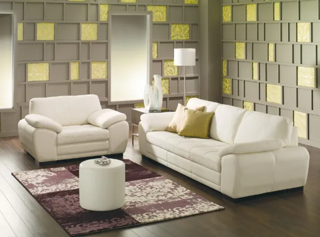 front view of a contemporary living room with a white oversized chair and matching sofa and coffee table.