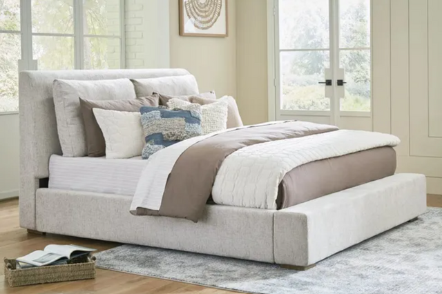 front view of a cream upholstered casual king bed