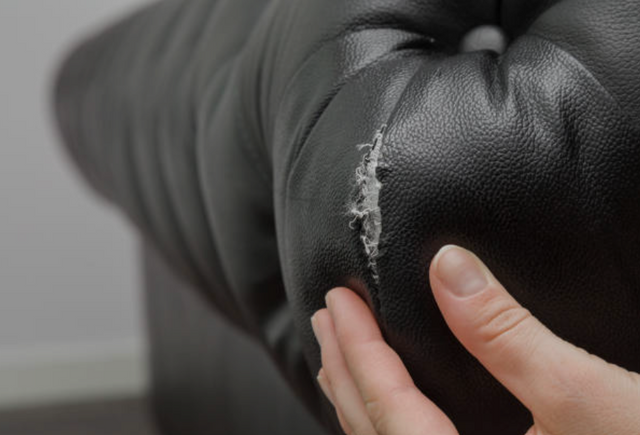 close view of a teat in a black leather sofa