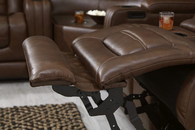close side view of a brown leather recliner leg rest extended out