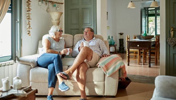 Older Couple Sitting on Reclining Loveseat