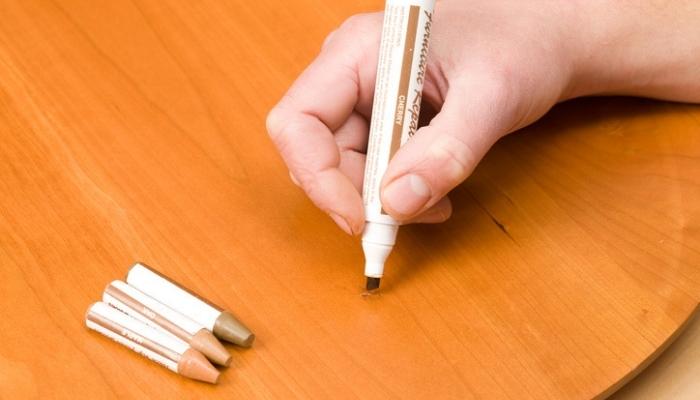 person using wood marker