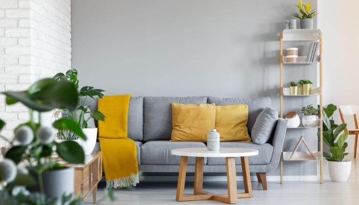 Living room featuring grey couch and bright yellow accents