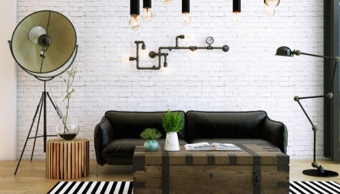 Industrial living room with exposed pipes and metal lamps