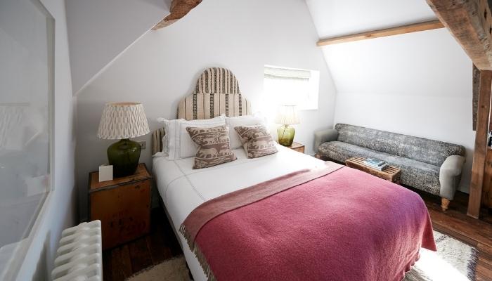 Woman preparing bed in guest room