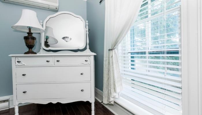 Guest room with pretty dresser and mirror