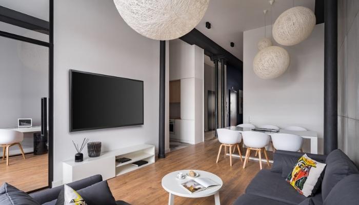 Stylish living room with ball lampshades and hanging tv