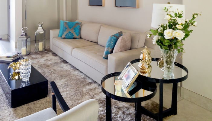 Closeup of two nesting side tables with glass mirror insets in a stylish living room