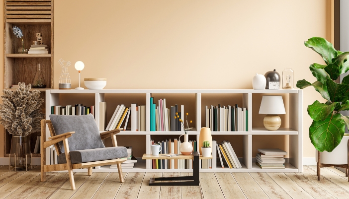 A home library with a bookshelf, comfy chair, and little table
