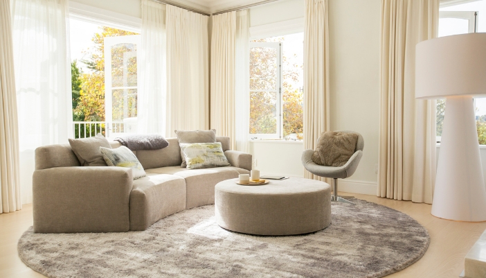 Warm and cozy living room with curved furniture