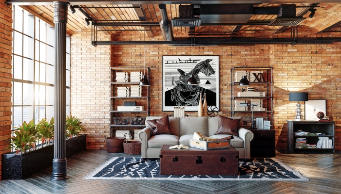 A modern living room with a brick wall and several book shelves.