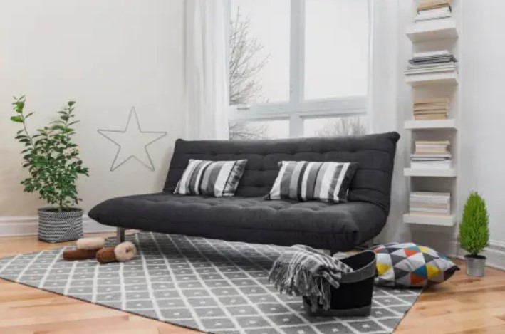front view of a black futon in a modern living space