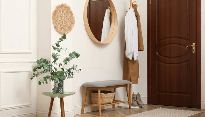 A home entryway with a bench and mirror.