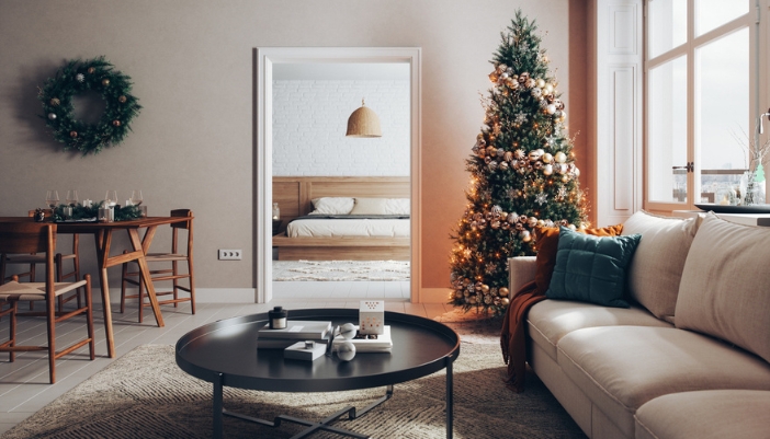 A small home decorated for the holidays with greens and a tree.