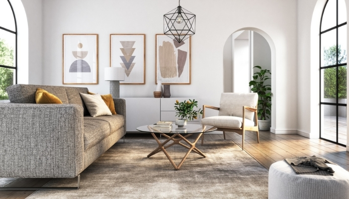A neutral gray colored living room with geometric paintings on the wall.
